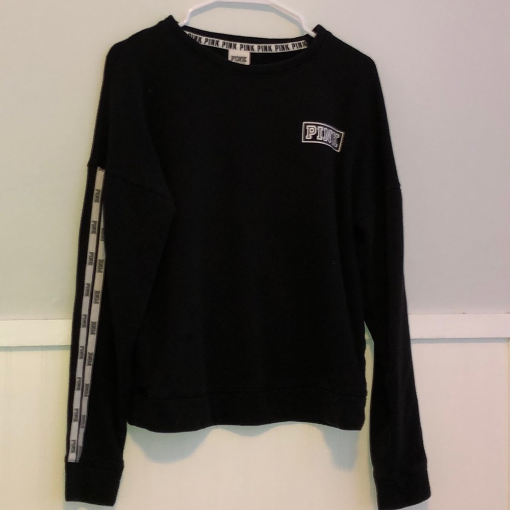 black crew neck with pink on the side in writing